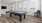 a room with a pool table and chairs